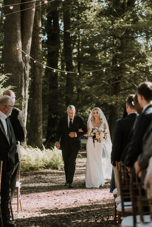 Larissa and her father, walking down the aisle, at Larissa & Ricky's wedding