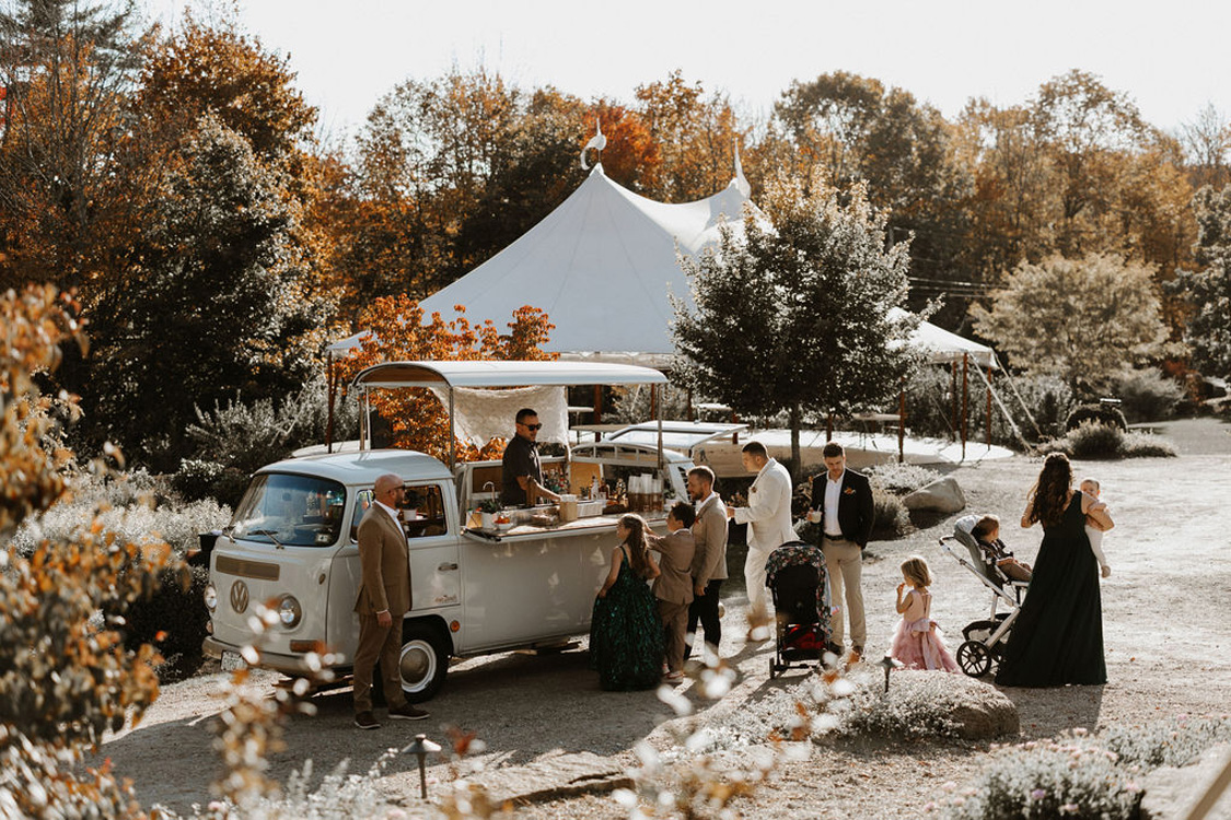 A vendor serving drinks during at wedding at The Gardens at Uncanoonuc Mountain.