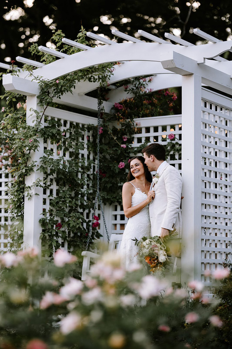 A photo of a married couple under the Rose Arch.